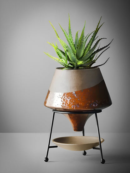 HongLuo Artisan Planters Family featuring a modern cone-shaped ceramic planter with rustic brown and beige glazing, mounted on black metal stand with catchment dish, displaying vibrant green aloe vera plant against grey background