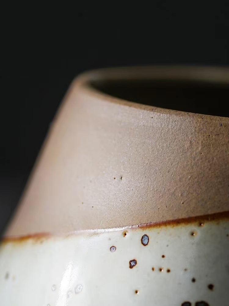 HongLuo Artisan Planters Family ceramic pot featuring a detailed macro shot of rustic two-tone design, with natural clay upper portion and speckled white glazed bottom, showcasing handcrafted texture and artisanal quality against dark background